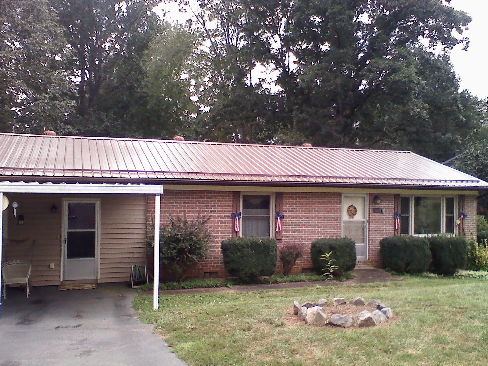Bronze metal roof and carport on a brick ranch home — Roof Repair work by our crew in Wallkill